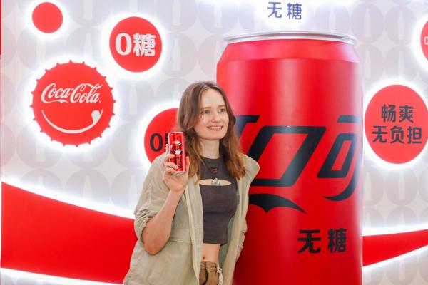 Borisenko Sofia, a Russian postgraduate student at Shanghai Jiaotong University, poses for a photo at the Swire Coca-Cola Kunshan new plant. (Photo provided to China Daily)