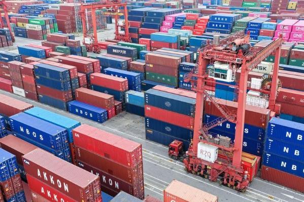 An aerial drone photo taken on March 20, 2026 shows vehicles transporting containers at a yard of Taicang Port in East China's Jiangsu province. (Photo: Xinhua)